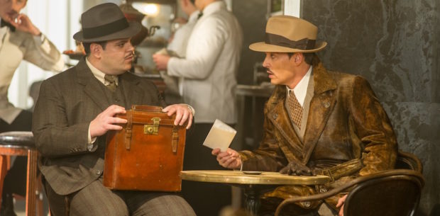 Josh Gad, left, and Johnny Depp star in Twentieth Century Fox’s “Murder on the Orient Express.”