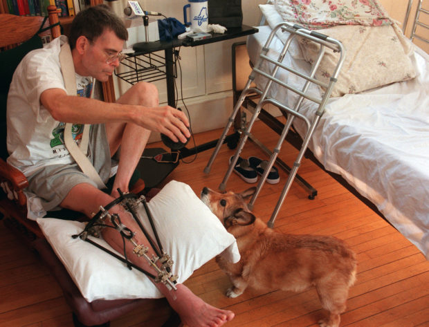 Stephen King plays with the family dog, Marlow, during a post-accident interview at his Bangor home.  BANGOR DAILY NEWS PHOTO BY KEVIN BENNETT.