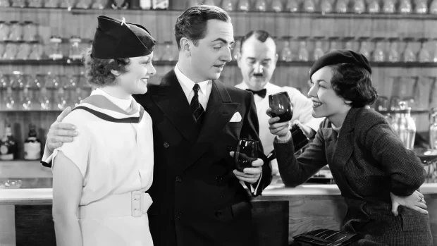 Myrna Loy and William Powell enjoy a chat and a drink in the stylish settings of The Thin Man (1934)