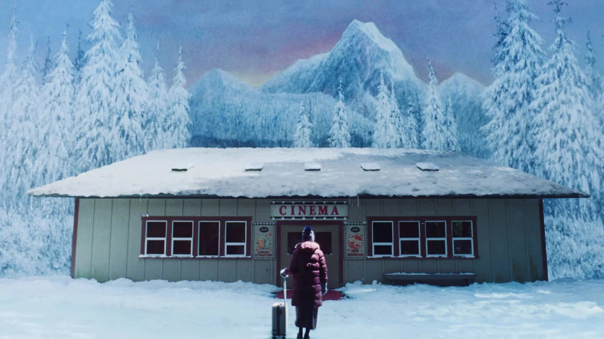 Hannah Einbinder stands in front of an unreal, wintry cinema in Teenage Sex and Death at Camp Miasma